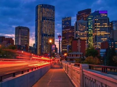 A view of the skyline of downtown Calgary illuminated under a sunrise sky.